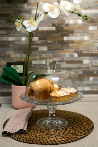 a glass plate with some pastries on a table at Residenza Piccoli Sogni in Comacchio