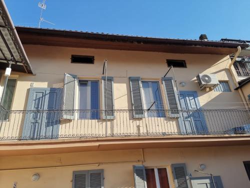 an apartment building with blue shutters and a balcony at AT HOME IN CREMONA in Cremona