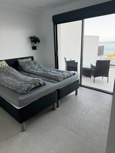 a bed in a room with a view of the ocean at El Mirador Casa #8 in Torrox Costa