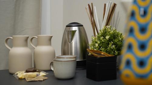 a table with vases and a coffee maker and a container at Residenza Piccoli Sogni in Comacchio
