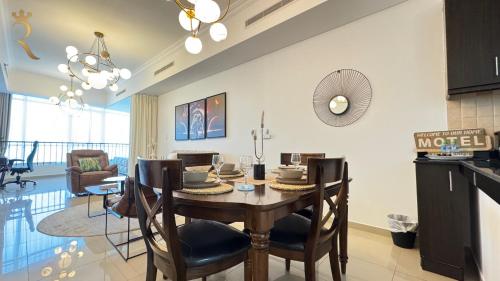 a kitchen and dining room with a table and chairs at Modern Urban Studio - Stylish Haven in Abu Dhabi