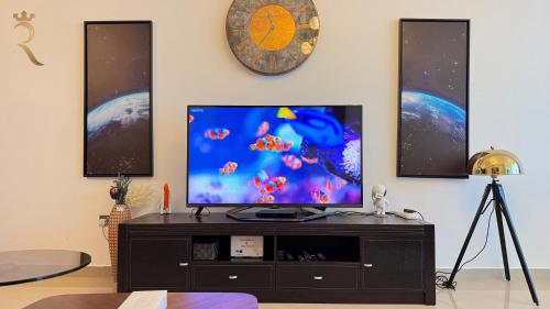 a flat screen tv sitting on top of a entertainment center at Modern Urban Studio - Stylish Haven in Abu Dhabi