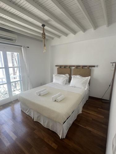 a bedroom with a bed with two towels on it at Myconian Avra Apartment in Mikonos