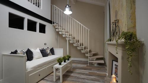 a living room with a staircase and a couch at Residenza Piccoli Sogni in Comacchio