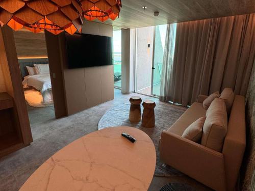 a living room with a couch and a table at Novotel Recife Marina in Recife