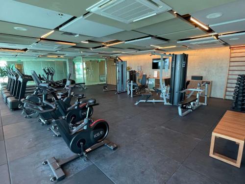 a gym with several treadmills and exercise bikes at Novotel Recife Marina in Recife
