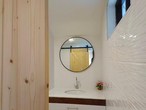 a bathroom with a sink and a mirror at Nangyuan Island Dive Resort in Koh Tao