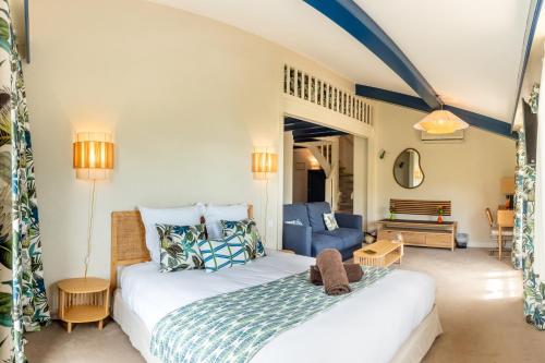 a bedroom with a bed and a blue couch at Le Domaine de Falgos Golf & Spa in Saint-Laurent-de-Cerdans