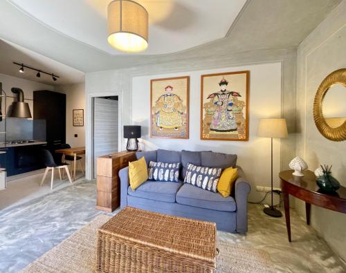 a living room with a blue couch and a table at Marty's House in Arezzo