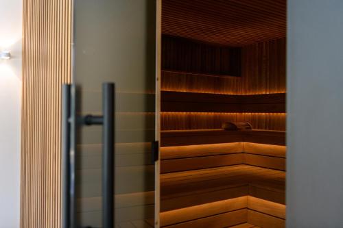 a row of wooden benches in a room at BERGlässig Hotel Bodenmais - 360 Grad Urlaub in Bodenmais