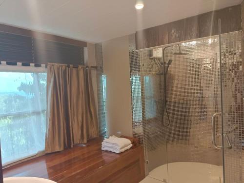 a bathroom with a shower and a glass shower stall at Nangyuan Island Dive Resort in Koh Tao