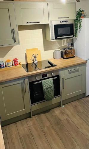 a kitchen with a stove and a counter top at The Lookout in Carbis Bay