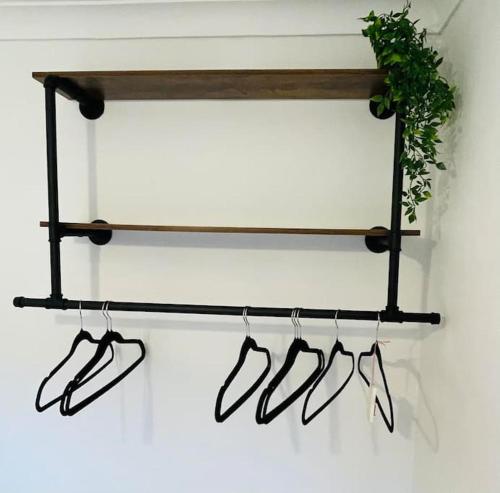 a shelf with pairs of shoes and a plant at The Lookout in Carbis Bay