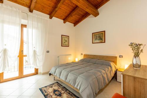 a bedroom with a bed and a large window at Chalet La Greta Vista Superiore in Firenzuola