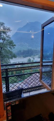 a window of a train with a view of the ocean at The Sana Luxury Stay, Manali in Manāli