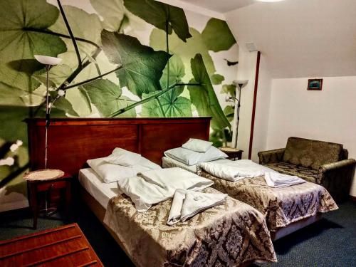 a hotel room with two beds and a mural at HOTEL RESTAURACJA WESOŁA in Lisia Góra