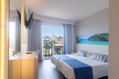 a hotel room with a bed and a large window at Seramar Hotel Luna Park Adults Only in El Arenal