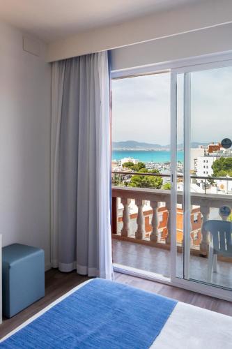 a bedroom with a view of the ocean at Seramar Hotel Luna Park Adults Only in El Arenal