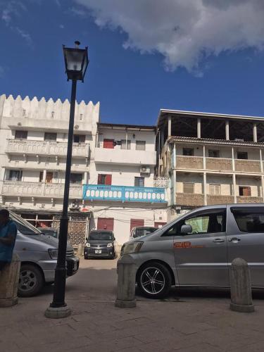 a street light and cars parked in a parking lot at Balcony Bliss & Private Bath at Mamdalis in Ngambo