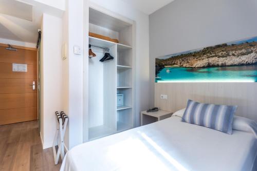 a bedroom with a bed with a painting on the wall at Seramar Hotel Luna Park Adults Only in El Arenal