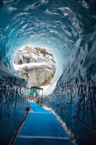 a blue carpeted tunnel in an ice cave at Apartment Lognan 1 - A Chamonix Mont Blanc Haven in Chamonix-Mont-Blanc
