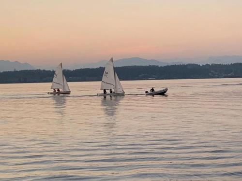 three small sailboats on a large body of water at Scorpion Hiuse Langley -ROOM A in Langley