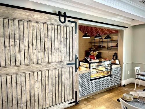 a sliding barn door in a kitchen with a table at The Weinberg Windhoek in Windhoek