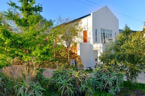 a white building with plants in front of it at Val Du Charron Wine & Leisure Estate in Wellington