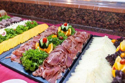 a buffet of food with meat and vegetables on at Seramar Hotel Luna Park Adults Only in El Arenal