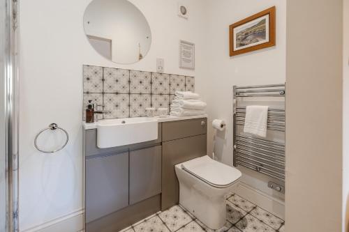 a bathroom with a toilet and a sink and a mirror at The Star Inn - Harbottle - Near Rothbury - Northumberland in Morpeth