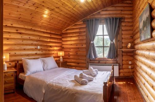 a bedroom with a bed in a log cabin at Mountain Escape Chalet in Karpenision