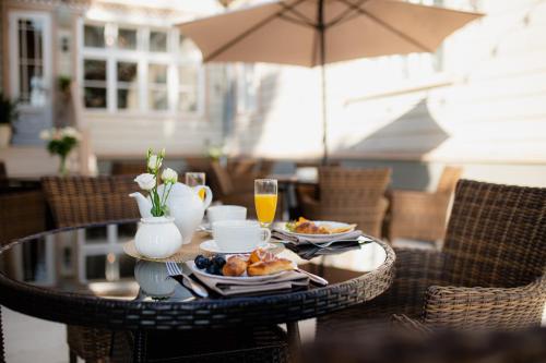 a table with a tray of food and drinks on it at Boutique Hotel Virkas muiža in Kuldīga
