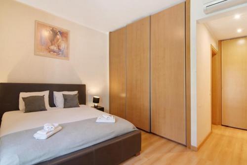 a bedroom with a bed with two towels on it at HolidaysPT - MyOasis I - T2 Apartment in Olhão