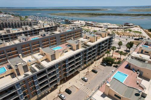 an aerial view of a city with buildings and the ocean at MyOasis II - Algarve in Olhão