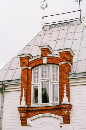 a window on the roof of a house at Boutique Hotel Virkas muiža in Kuldīga