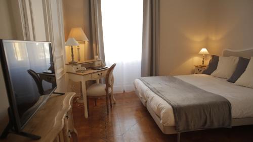 a bedroom with a bed and a desk with a mirror at Ponterosso Suite in Trieste