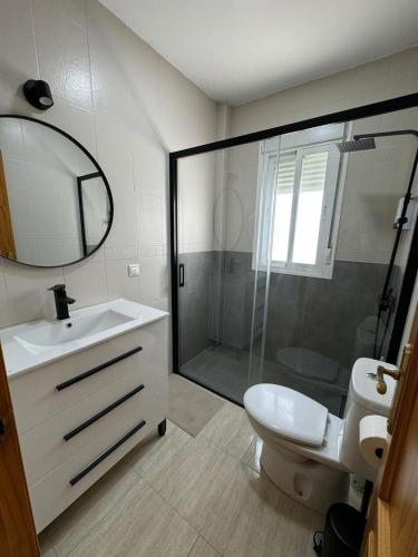 a bathroom with a shower and a sink and a toilet at Apartamentos Modern Homes in Chiclana de la Frontera