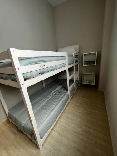 two bunk beds in a small room at Apartamentos Modern Homes in Chiclana de la Frontera