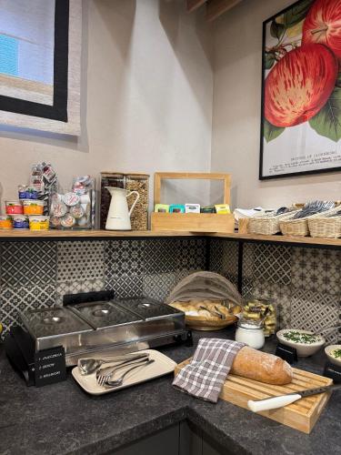 a kitchen counter with bread and other items on a shelf at Zamkowe Apartamenty in Sandomierz