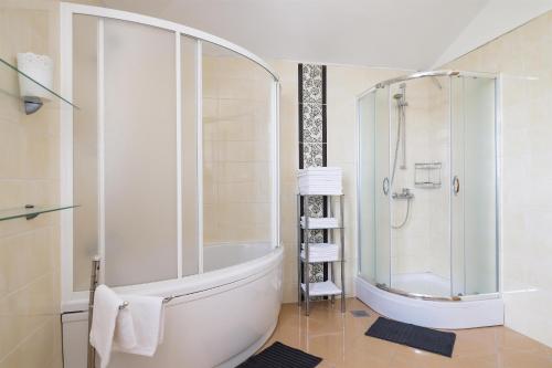 a bathroom with a large tub and a shower at House Anna in Drage
