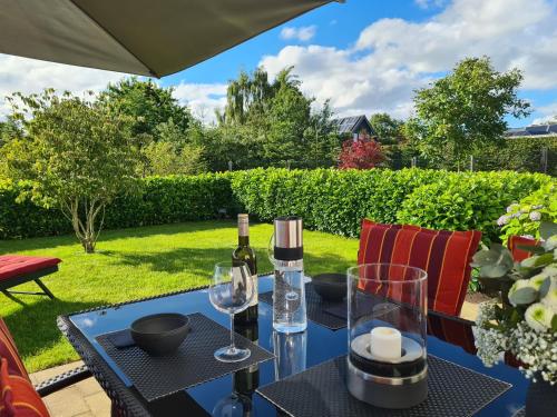 - une table avec des bouteilles de vin et des verres sur la terrasse dans l'établissement Eilers, Katja Lilly, Ferienwohnung Lilly, à Varel