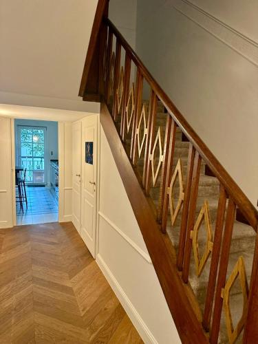 a staircase in a home with wooden railings at Pétrusse Élite Suites in Luxembourg