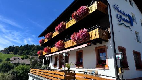 a building with flowers on the side of it at Boutique Hotel and Apartments Pension Sternen in Todtmoos