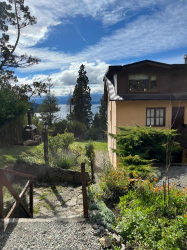 a house with a fence in front of it at Cabaña La Calandria in San Carlos de Bariloche
