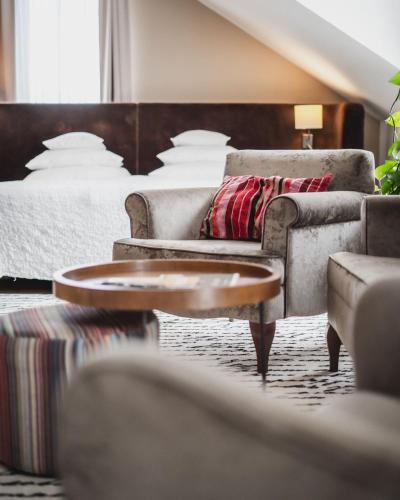 a living room with a couch and a bed at Grand Hotel Boutique in Rzeszów