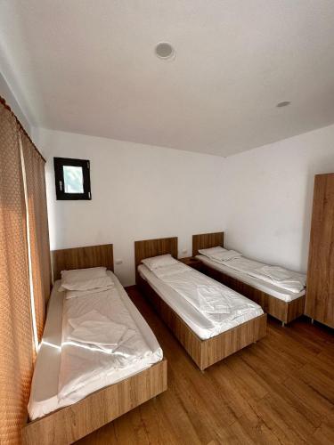a room with two beds and a window at Complex Popas Pacurari in Iaşi