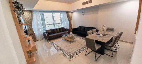 a living room with a table and a couch at Royal Home in Abu Dhabi