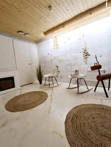a living room with two chairs and a fireplace at Goiglo Hotel & Hostel in Kuusamo
