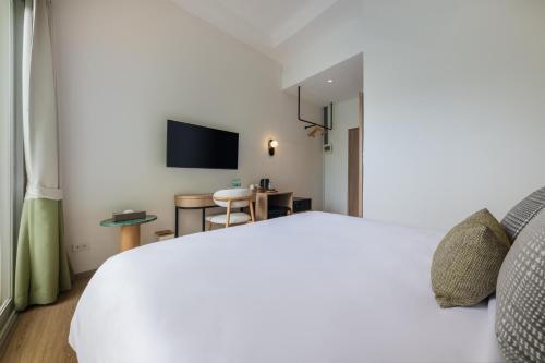 a hotel room with a bed and a desk at Upstairs at Ton Ton in Bangkok