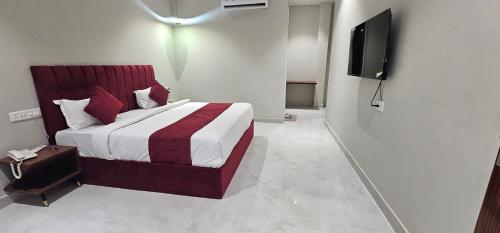 a hotel room with a bed and a television at Hotel K9 Regency sirsa in Sirsa